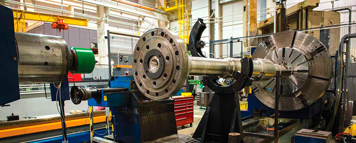The RCP shaft is placed in the lathe to measure total indicated runouts (TIR).