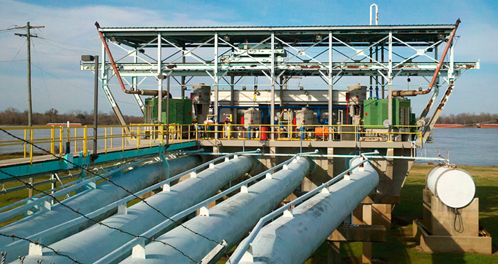 Image 1. Pump motors and engines are shown in an outdoor pumping station inside a Mississippi River levee, before the addition of eddy current drives.