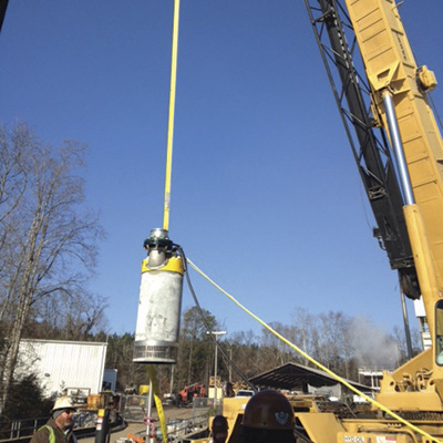 A crane lowered the pump into the river