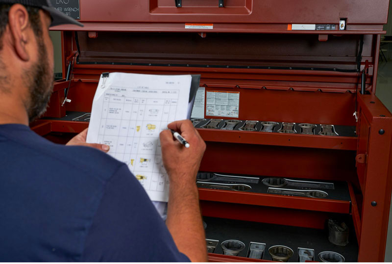 A technician performs a visual inspection of kit box contents ahead of a scheduled outage.