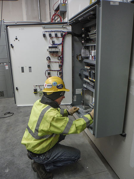 Worker adjusting controls