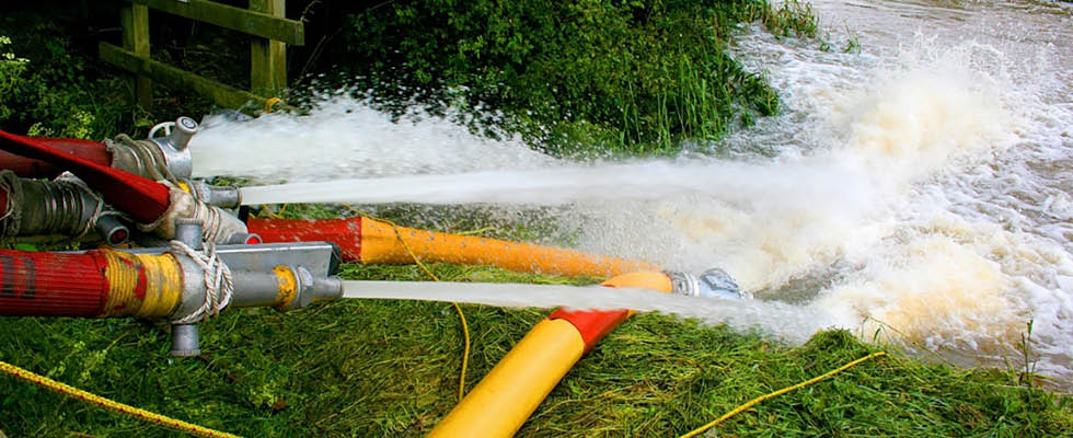 IMAGE 2: High-volume water pipes pumping flood water away from residential area