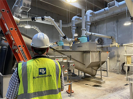 IMAGE 1: Reliability maintenance expert surveys water treatment facility (Images courtesy of Black & Veatch)