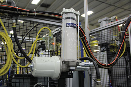 IMAGE 2: The automatic lubrication pump supplies pressurized grease or oil to the metering device, providing fluid power to the system.