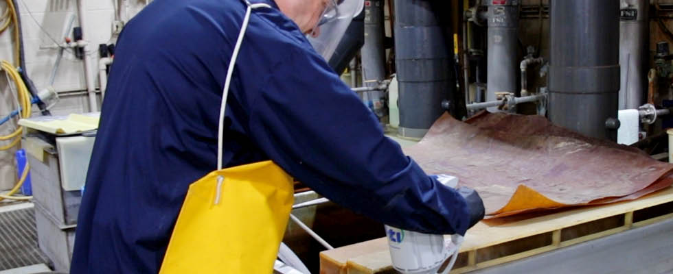 IMAGE 1: Employee using personal protective equipment (PPE), transfering corrosive chemicals (Images courtesy of Finish Thompson)