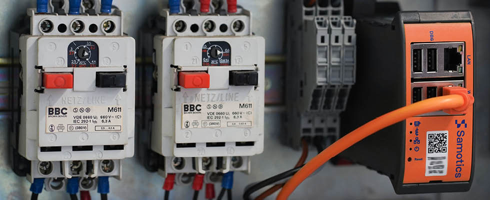 IMAGE 1: An ESA system installed in a motor control cabinet. The orange box is the data acquisition device, with connections to each of the three phases of current and voltage. (Images courtesy of Samotics)