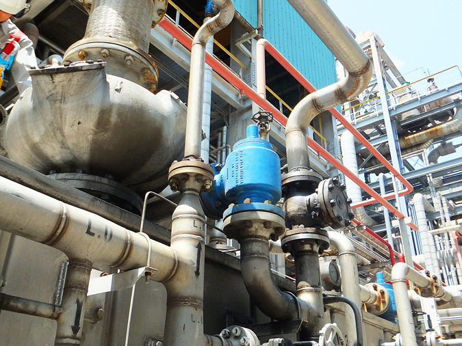 A guided piston valve controls line pressure at an oil refinery