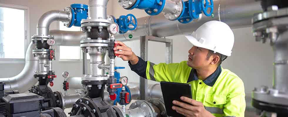 Worker using AI in predictive maintenance in water facility 