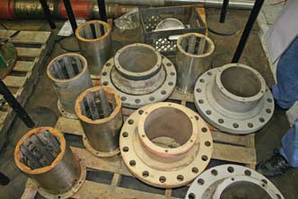 Disassembled flanged bearing housings with failed rubber cutlass bearings remove