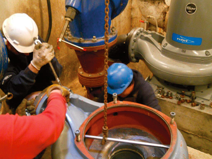 Workers place and secure the volute before the remainder of the pump is received.