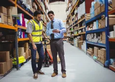 Manager and worker in a warehouse