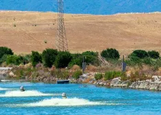 Three electric motor-driven aerators working to oxygenate water in a treatment pond