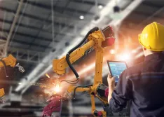 industrial worker monitoring robotics in industrial setting