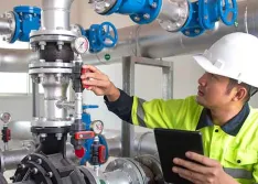 Worker using AI in predictive maintenance in water facility 